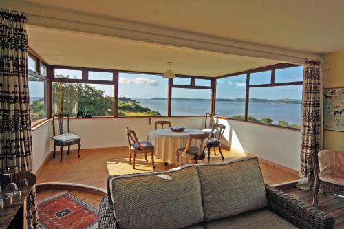a living room with a table and a view of the ocean at 3 Bed in Duncannon oc-i041 in Duncannon