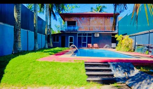 a house with a swimming pool in the yard at Diamond Pool House in Panadura