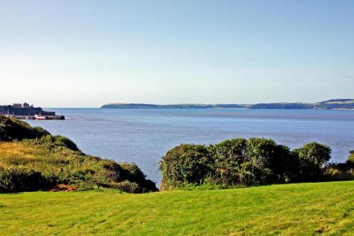 a grassy hill with a view of a body of water at 3 Bed in Duncannon oc-i041 in Duncannon