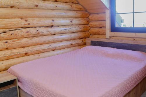 a bedroom with a bed in a wooden wall at Cherry House Ohanavan by Amaranoc am in Oganavan