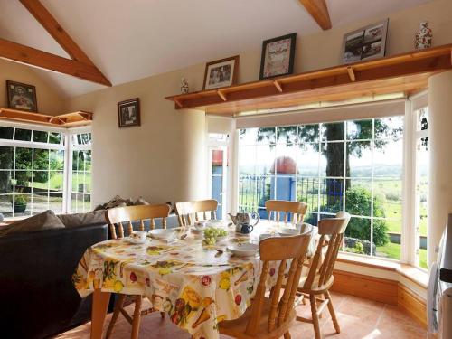 a dining room with a table and chairs and a couch at 2 Bed in Lismore oc-ii06400 in Tallowbridge