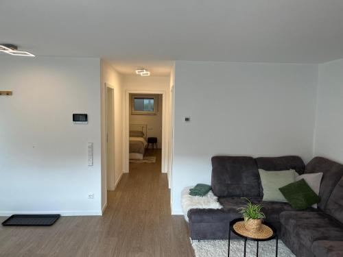 a living room with a couch and a table at Helles & modernes Apartment mit privater Terrasse in Schwäbisch Hall