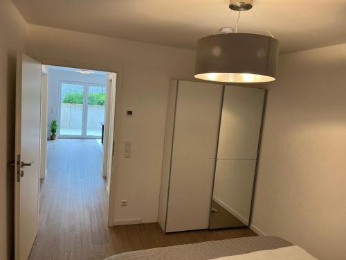 a room with a closet and a mirror and a light at Helles & modernes Apartment mit privater Terrasse in Schwäbisch Hall
