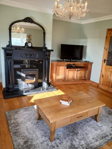a living room with a coffee table and a fireplace at 4 Bed in Annascaul oc-ii08305 in Inch