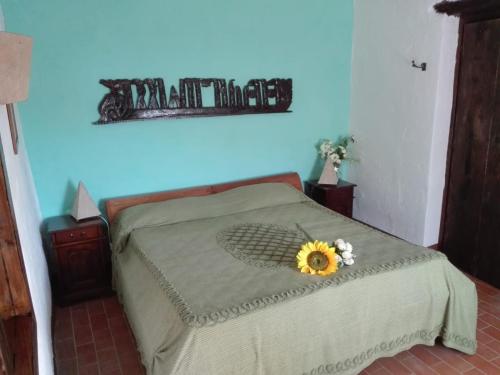 a bedroom with a bed with a sunflower on it at Domus Buontempo in Palestrina