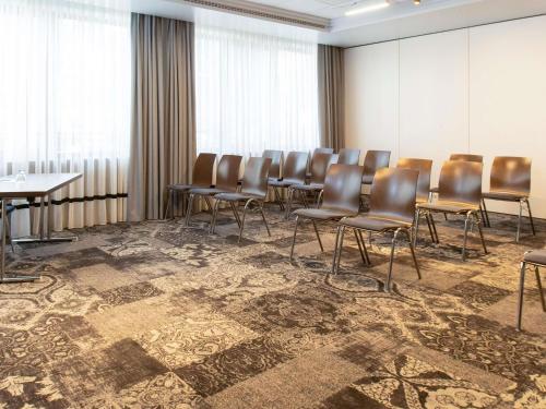 a conference room with chairs and tables in it at Mercure Hotel Frankfurt Airport Langen in Langen