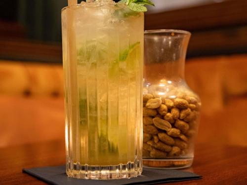 a vase with a drink and a vase filled with nuts at Mercure Hotel Frankfurt Airport Langen in Langen