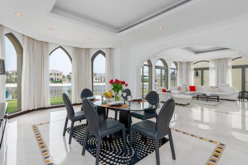 a dining room with a table and chairs at Palm Villa F, Palm Jumeirah - Mint Stay in Dubai