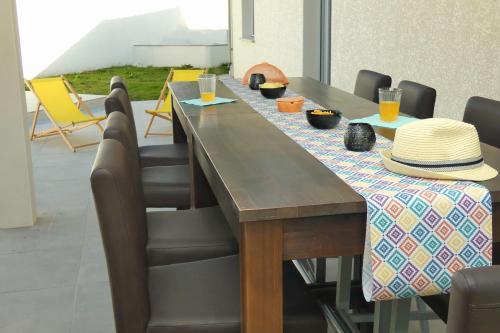 a long wooden table with chairs and hats on it at L'HACIENDA DUO a romantic getaway with a private spa in Charavines