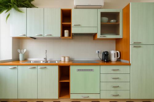 a kitchen with white cabinets and a sink at AQUARAMA - private pool - Lakefront apartment end free parking in Paratico