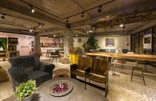 a living room with a large table and chairs at Beimen WOW Poshtel in Taipei