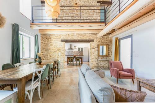 a dining room with a table and chairs at La Bastide du Père Mathieu Jacuzzi couvert et Piscine in Suze-la-Rousse