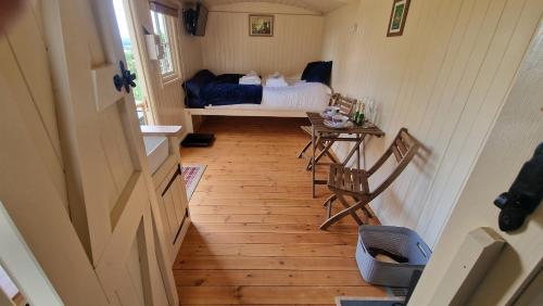 a bedroom with a bed and a table and chairs at Robin in Priston