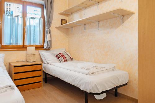 a bedroom with two beds and a window at Apartment Goldener Schnee Tesero in Tesero