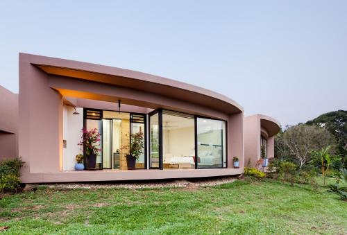 a modern house with large glass windows at Hotel Casa Ambrosia in Villeta