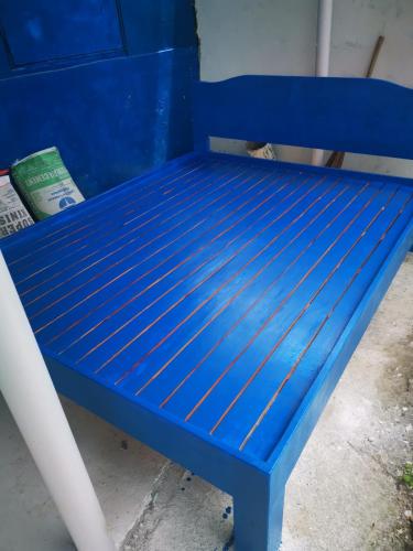 a blue bench sitting next to a blue wall at B'lu Bamboo in Moalboal