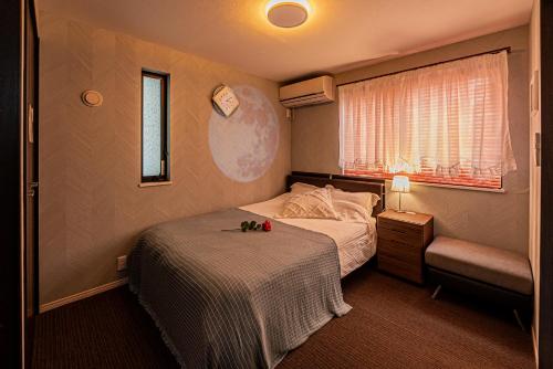 a small bedroom with a bed and a window at Ikebukuro house with 3BR Shinjuku 5min in Tokyo