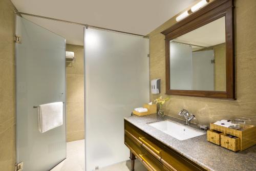 a bathroom with a sink and a shower at The Fort House, Diu- IHCL SeleQtions in Diu