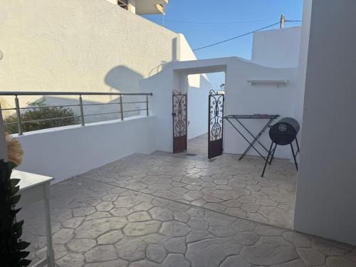 a balcony of a white building with a table on it at Traditional House 1925 in Gennadi