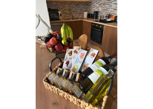 a basket full of wine bottles and fruit in a kitchen at Traditional House 1925 in Gennadi