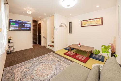 a living room with a couch and a table at Ikebukuro house with 3BR Shinjuku 5min in Tokyo