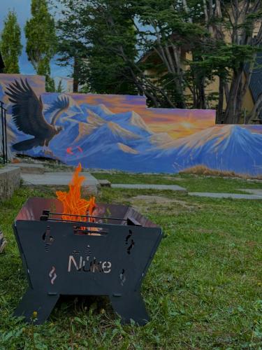 a fire pit with a sign that says nine at El Condor Fueguino II in Ushuaia