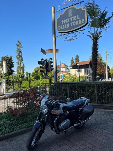 a black motorcycle parked in front of a hotel dublin tower at Hotel Della Torre in Stresa