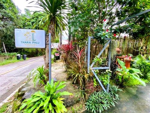 a sign for a garden with plants and a fence at THARA PHLU BUNGALOWS Koh Chang in Ko Chang