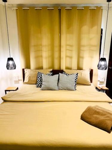 a bedroom with a large bed with three pillows at THARA PHLU BUNGALOWS Koh Chang in Ko Chang