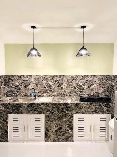 a kitchen with a sink and two lights at THARA PHLU BUNGALOWS Koh Chang in Ko Chang