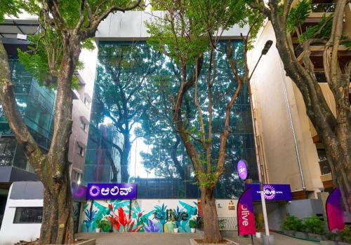 a group of trees in front of a building at Olive Hotel Indiranagar 100Ft Road by Embassy Group in Bengaluru