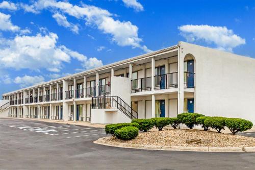 a building with a parking lot in front of it at Relax Inn by OYO Columbus OH I 70 in Columbus