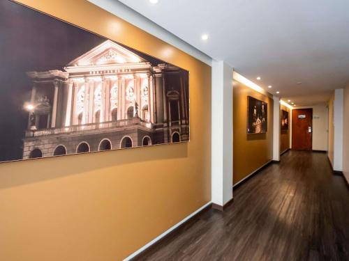 a hallway with a painting of a building on the wall at ibis Styles Belem Nazare in Belém