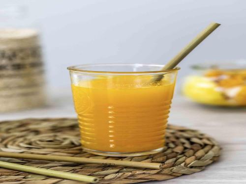 a glass of orange juice on a table with chopsticks at ibis Styles Belem Batista Campos in Belém
