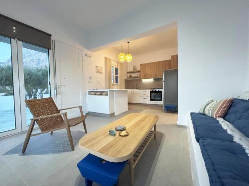 a kitchen and living room with a table and a couch at The Blue Eye of Kalymnos in Kalymnos