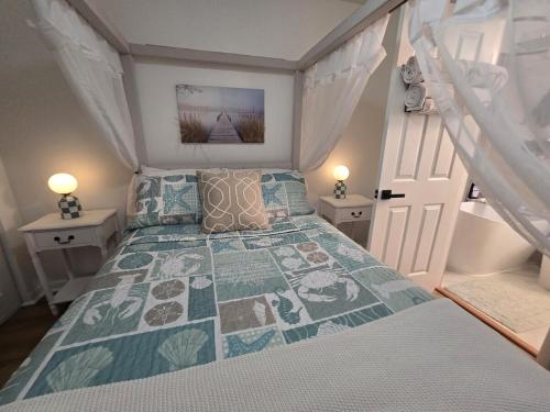 a bedroom with a bed and two night stands at Paradise Villa in Titusville