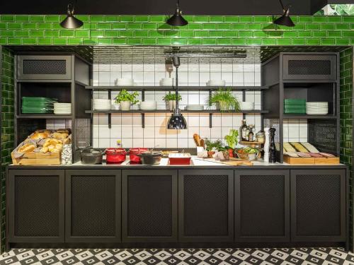 a kitchen with a counter with food on it at ibis Styles Amsterdam Airport in Schiphol