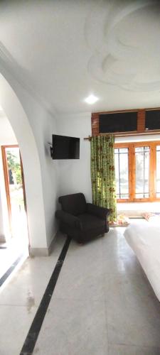 a living room with a couch and a window at Greenoriva - D2 - Greenery & Peace in Srinagar