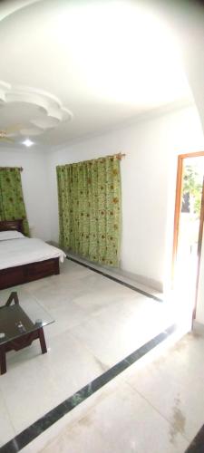 a white room with a bed and a window at Greenoriva - D2 - Greenery & Peace in Srinagar