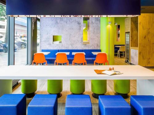 a conference room with a table and orange chairs at Íbis Budget Uberlândia in Uberlândia