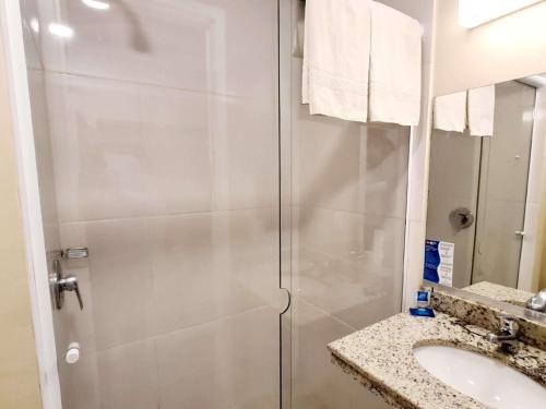 a bathroom with a shower and a sink at ibis budget Petropolis in Petrópolis