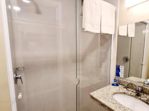 a bathroom with a shower and a sink at ibis budget Petropolis in Petrópolis