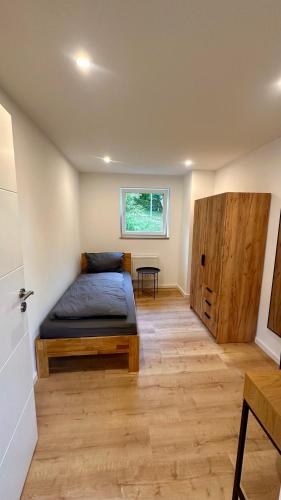 a bedroom with a bed and a window at Ferienwohnung Anja in Münnerstadt