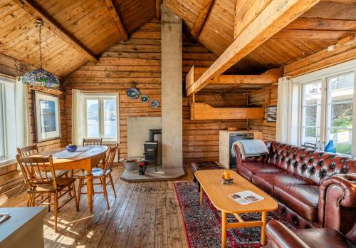 a living room with a couch and a table at Sakrisøy Rorbuer in Reine
