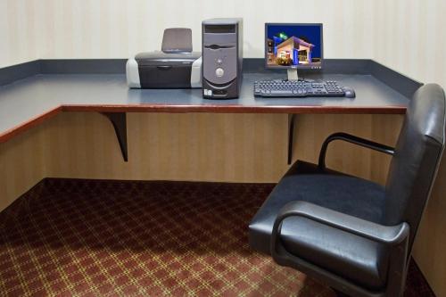 a desk with a computer and a printer and a chair at Holiday Inn Express Hotel & Suites Drums-Hazelton by IHG in Drums