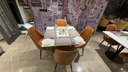 a table in a restaurant with chairs around it at Taj Executive Hotel Islamabad - Luxury Stays Opposite Jinnah Super F-7 in Islamabad