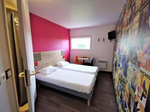 a small room with a bed and a red wall at HotelF1 Bourges Le Subdray in Bourges