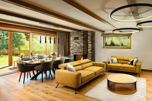 a living room with a table and a dining room at Chalet Oasis - Luxury Retreat at Chalets Kvačianska Dolina in Zuberec