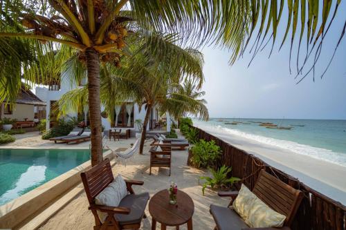 a view of the beach from the balcony of a resort at Babu Villas in Jambiani