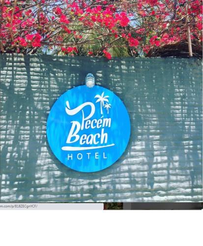 a sign for a beach hotel on a wall at Pecem Beach Hotel - Aval Hotel in Pecém